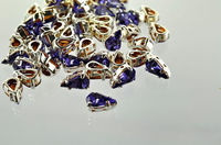 Swarovski в серебряных цапах 4300/2 Tanzanite 10х6мм Австрия